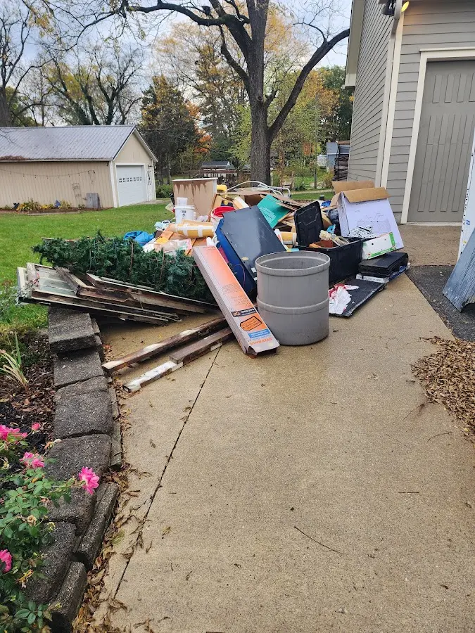 Dumpster being loaded with debris for Estate Cleanout Dumpster Rental in Fairwood